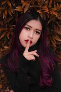 woman s index finger on her lips